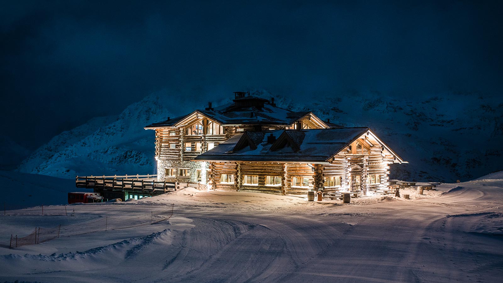 The mountain lodge at night shines with lights